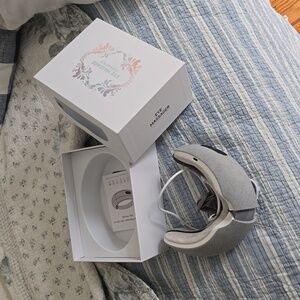 NIB Eye massager for migraines with heat and built-in music.